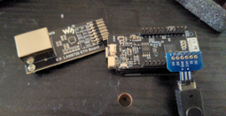 An ethernet module next to an esp32-s3 board which has a gb link cable connected to a breakout connected to its gpio pins